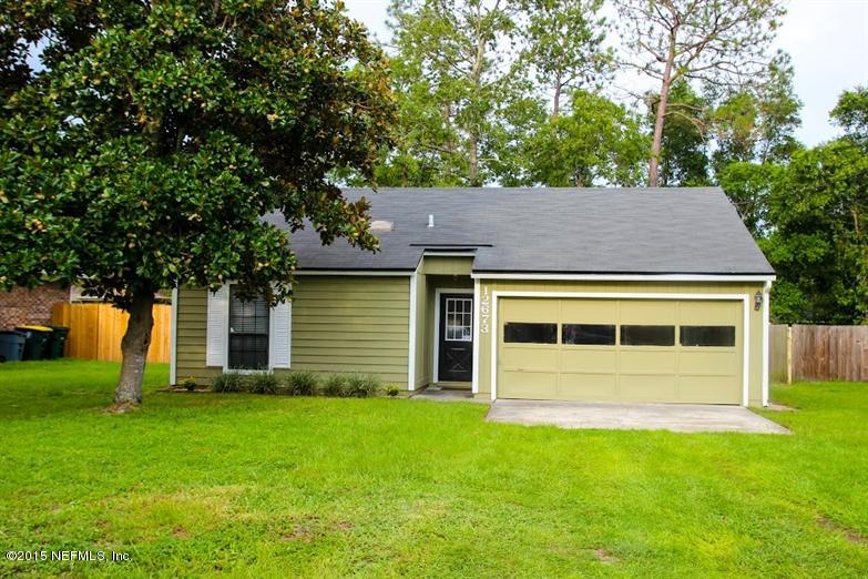 12673 Attrill Road Jacksonville, FL 32258 - Photo 1 of 16 a view of a house with a yard and large tree