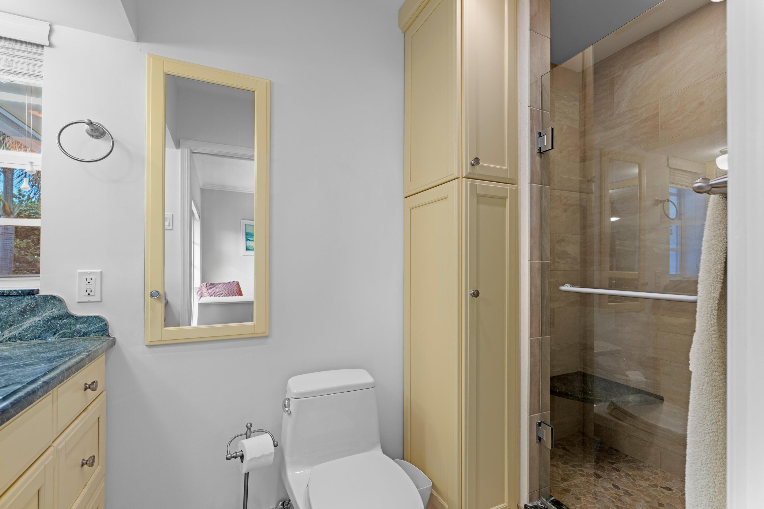 858 Hickory Terrace Boca Raton, FL 33486 - Photo 13 of 43 a bathroom with a granite countertop toilet sink and shower