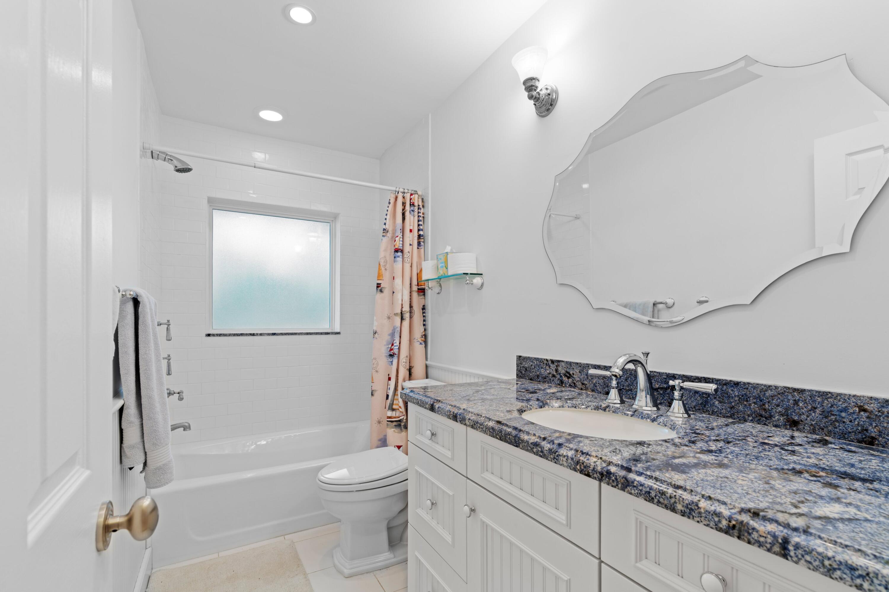 858 Hickory Terrace Boca Raton, FL 33486 - Photo 15 of 43 a bathroom with a granite countertop sink toilet and shower