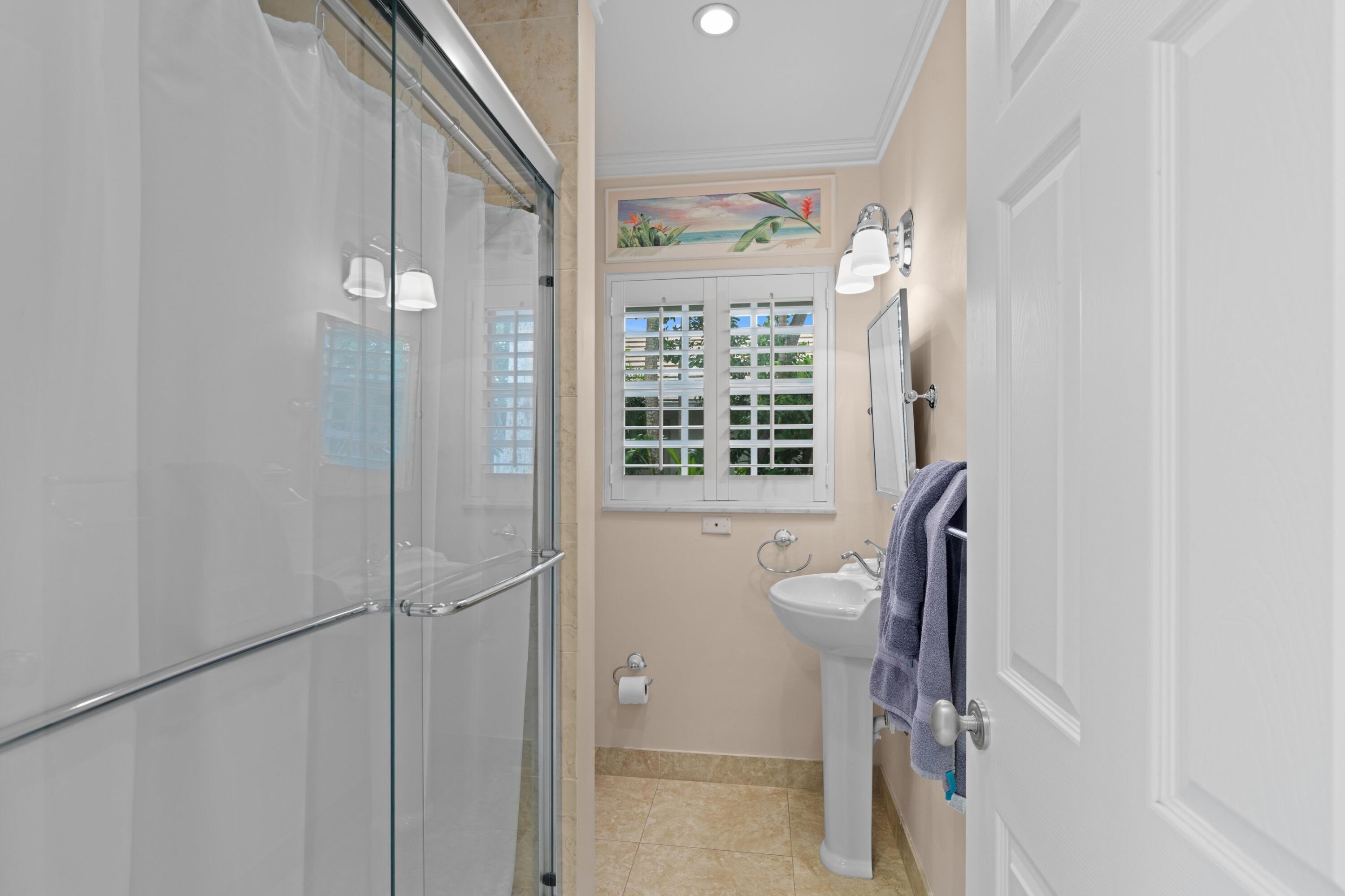 858 Hickory Terrace Boca Raton, FL 33486 - Photo 17 of 43 a view of a bathroom with a glass door