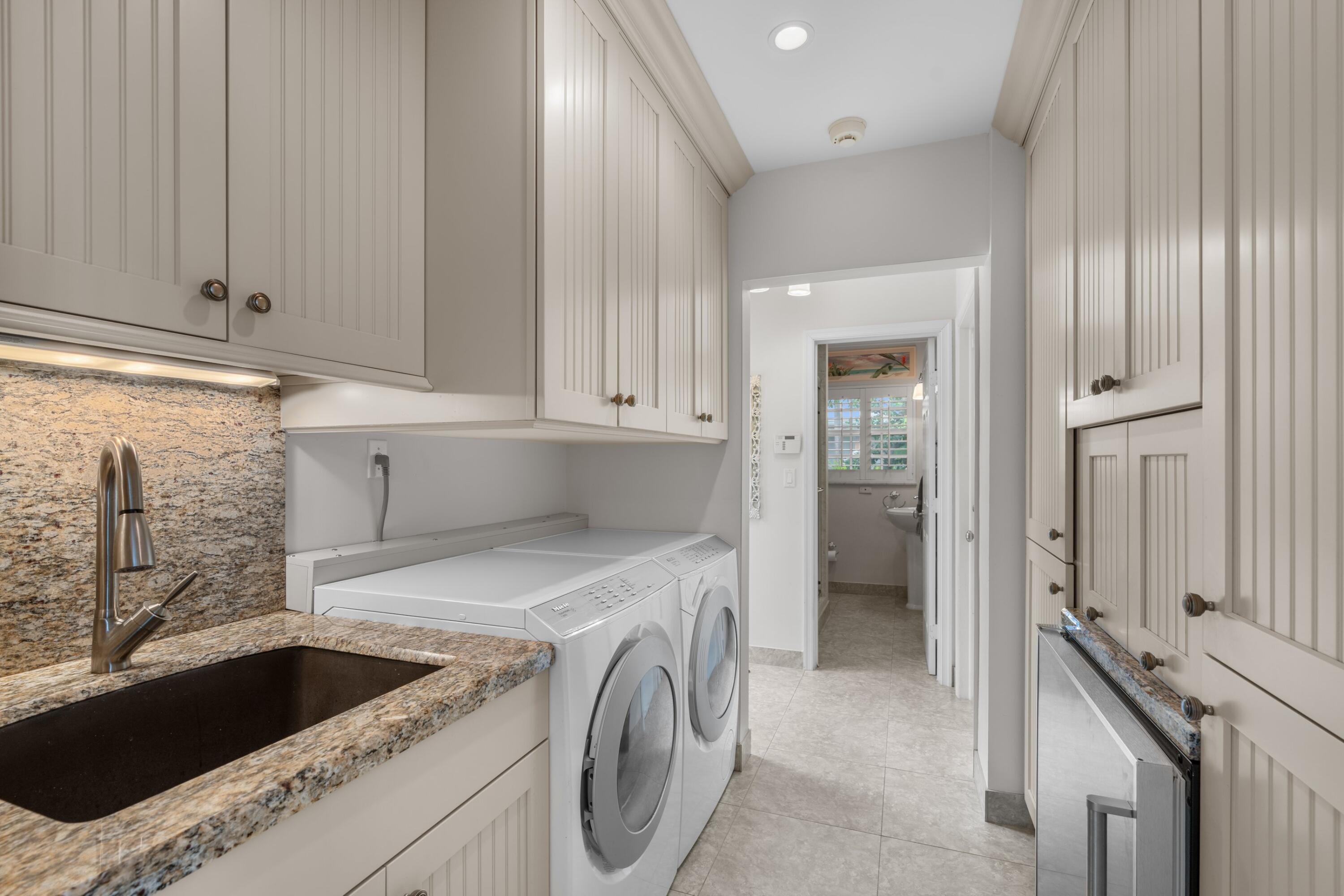 858 Hickory Terrace Boca Raton, FL 33486 - Photo 18 of 43 a view of a kitchen that has a sink and cabinets in it