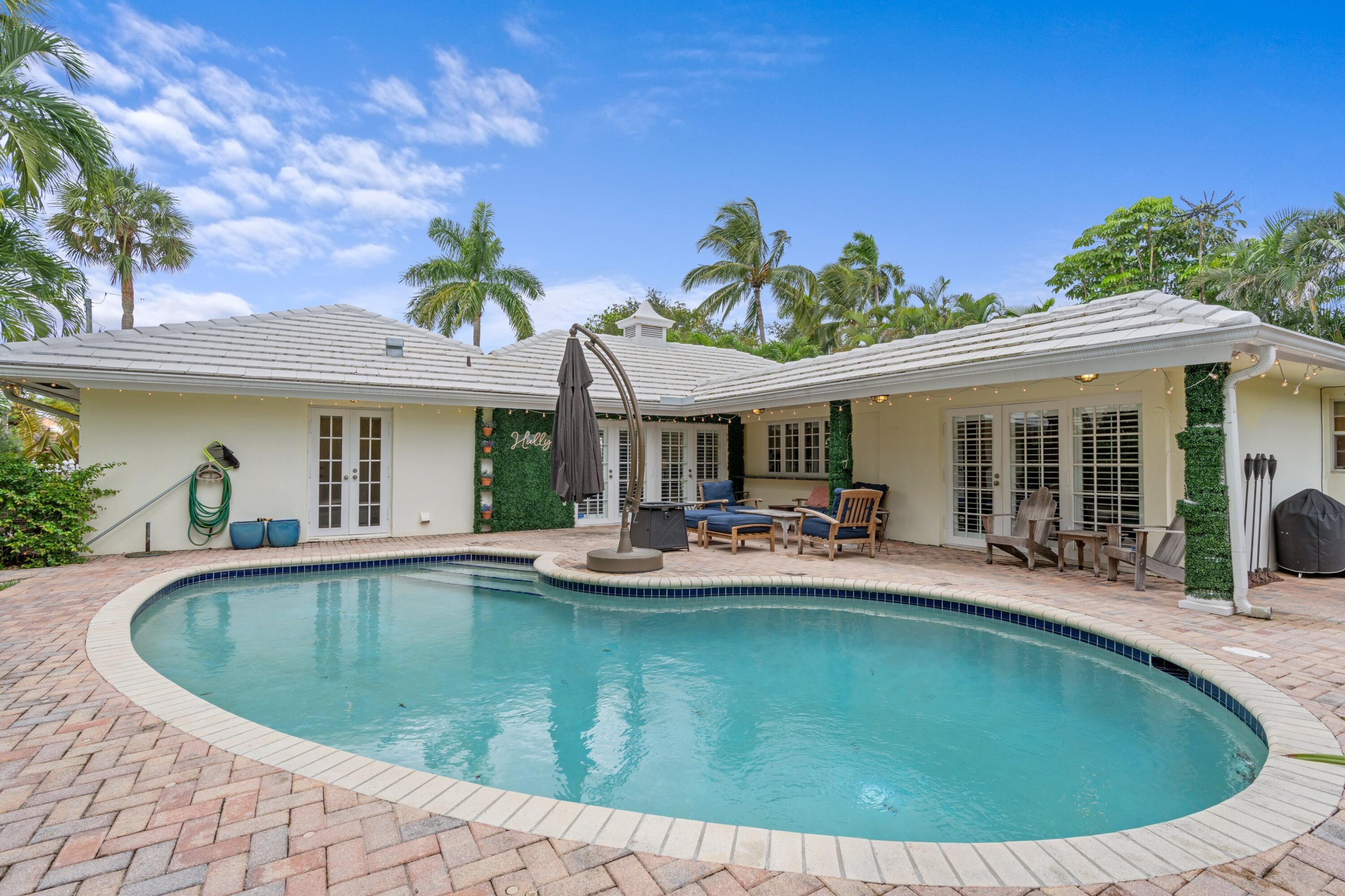 858 Hickory Terrace Boca Raton, FL 33486 - Photo 21 of 43 a view of a house with swimming pool and sitting area