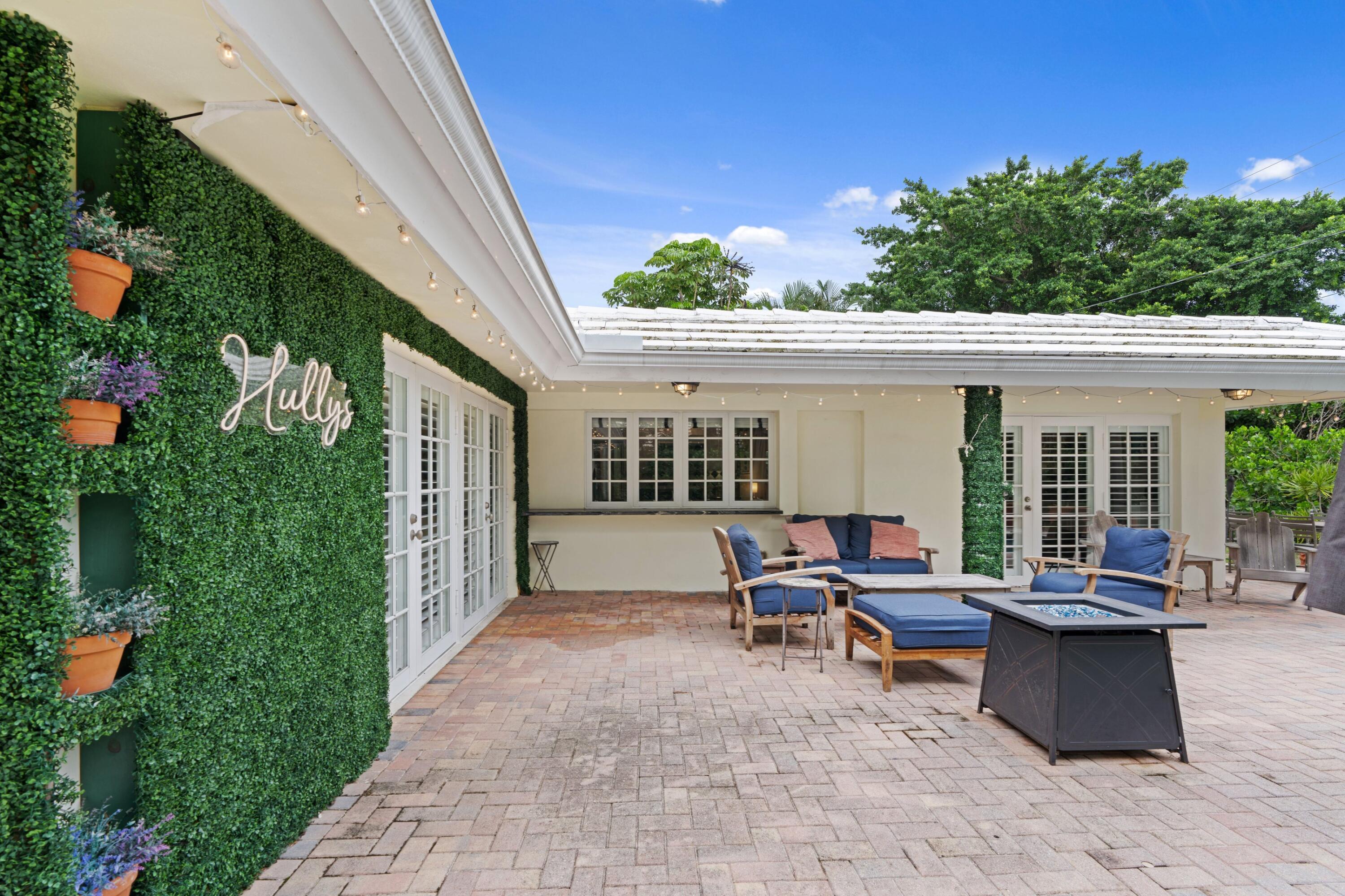 858 Hickory Terrace Boca Raton, FL 33486 - Photo 22 of 43 a view of a patio with table and chairs and potted plants