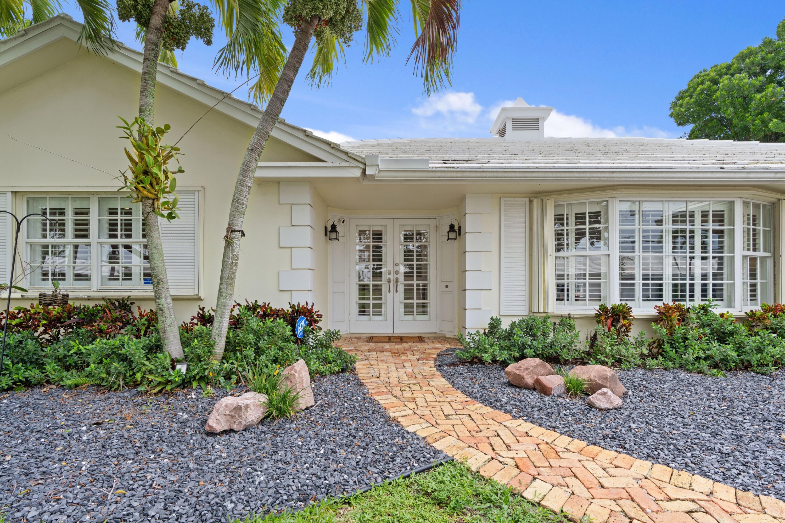 858 Hickory Terrace Boca Raton, FL 33486 - Photo 25 of 43 a view of a house with potted plants