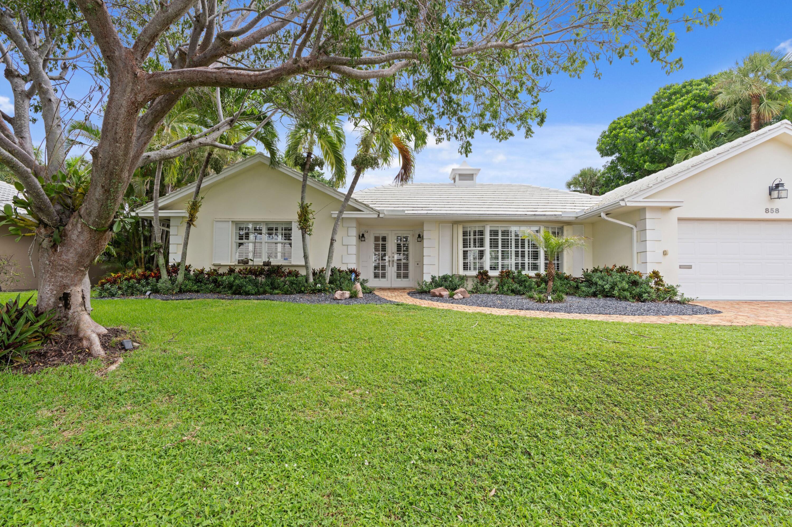 858 Hickory Terrace Boca Raton, FL 33486 - Photo 26 of 43 a front view of a house with garden