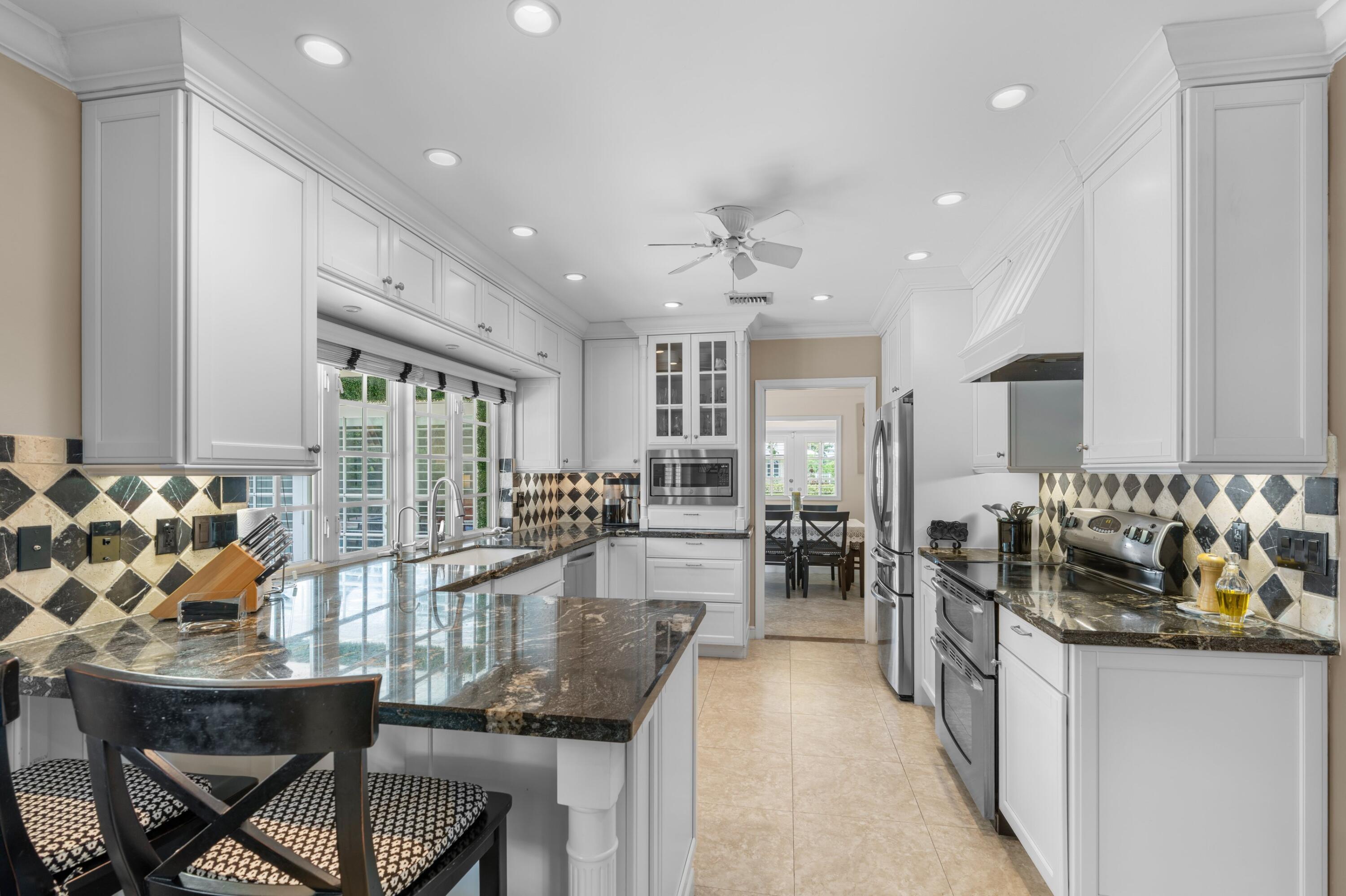 858 Hickory Terrace Boca Raton, FL 33486 - Photo 4 of 43 a kitchen with counter top space and dining table