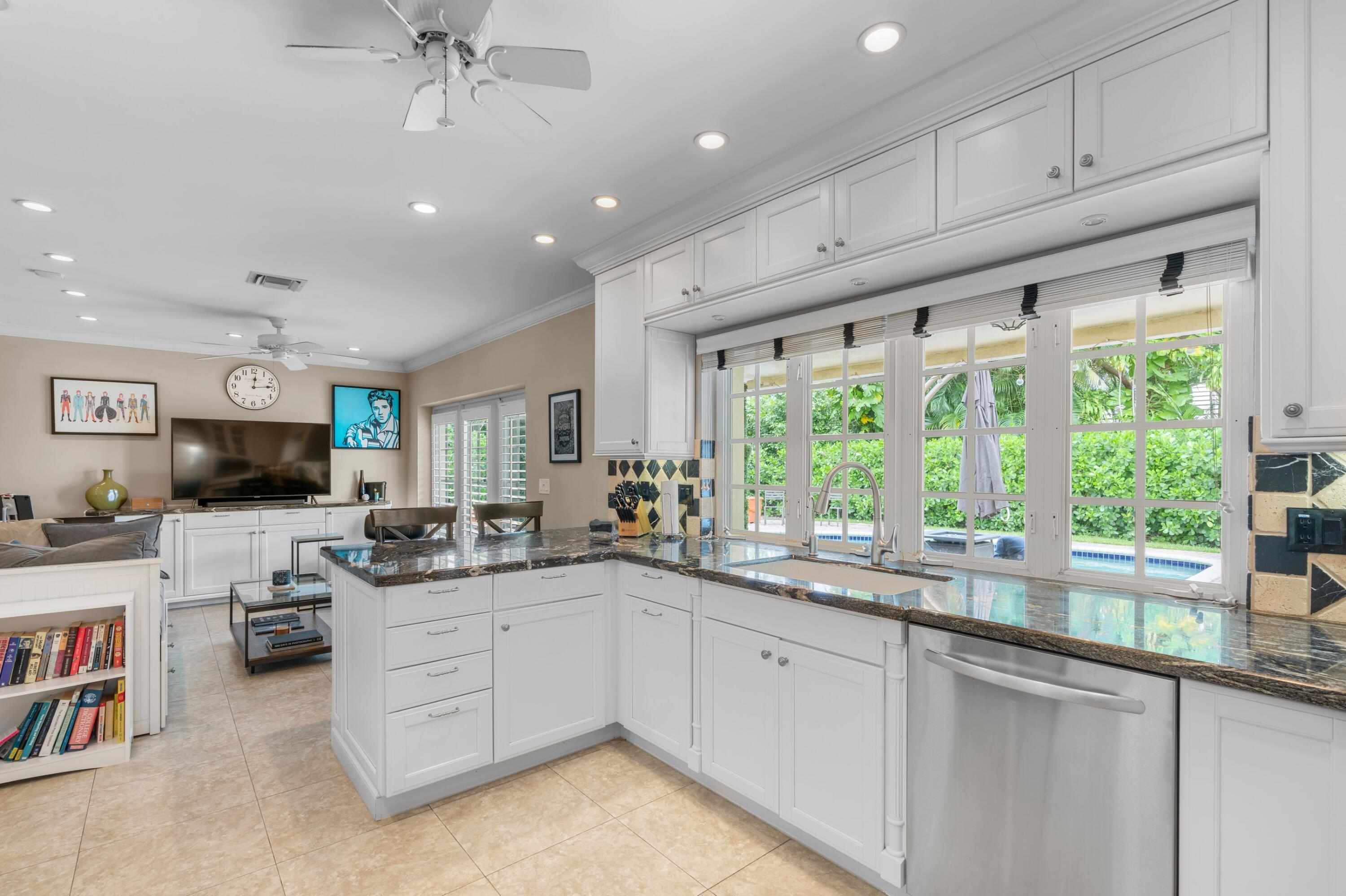 858 Hickory Terrace Boca Raton, FL 33486 - Photo 5 of 43 a kitchen with a sink stove and cabinets
