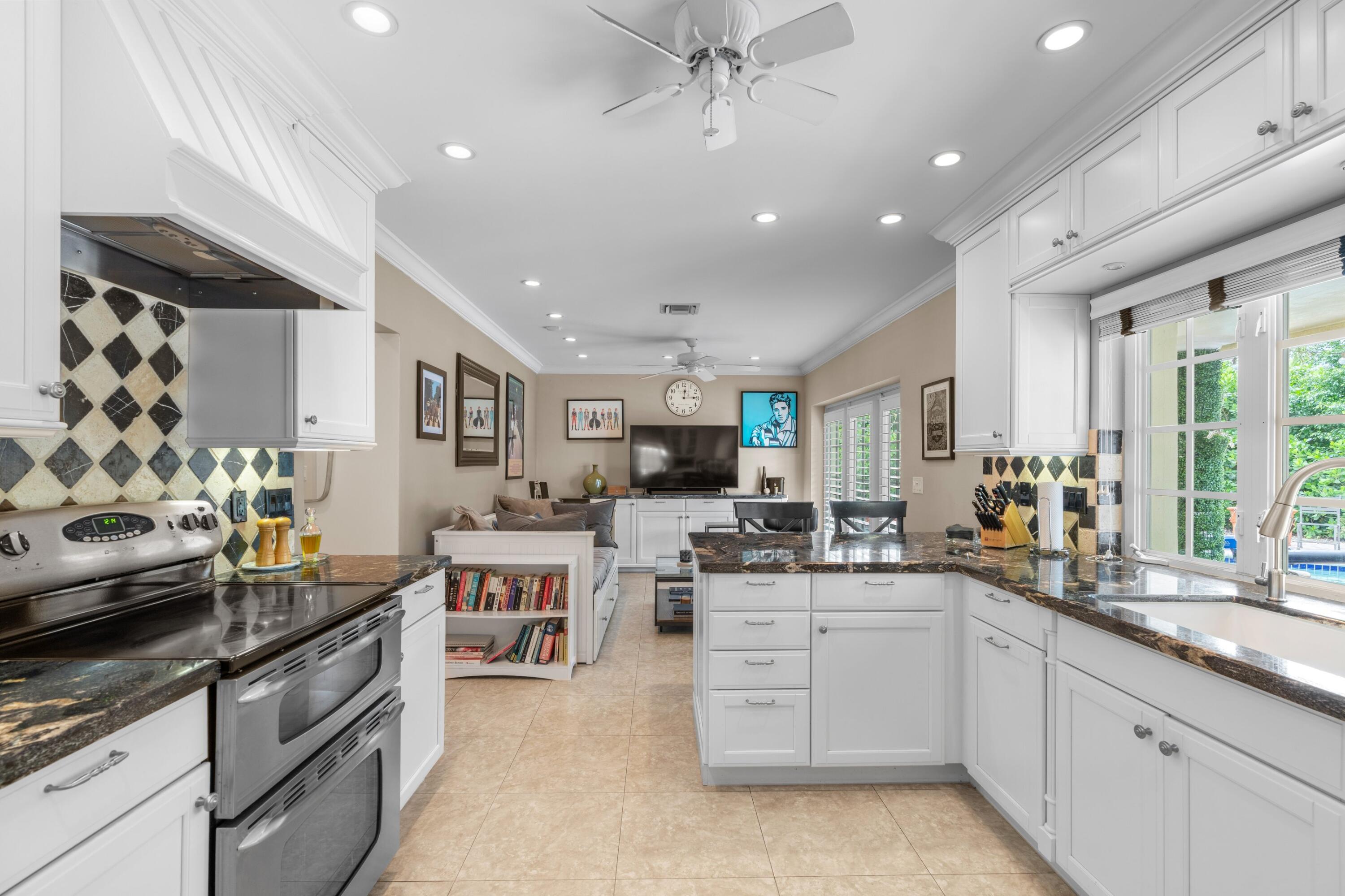 858 Hickory Terrace Boca Raton, FL 33486 - Photo 6 of 43 a kitchen with a sink stove and cabinets