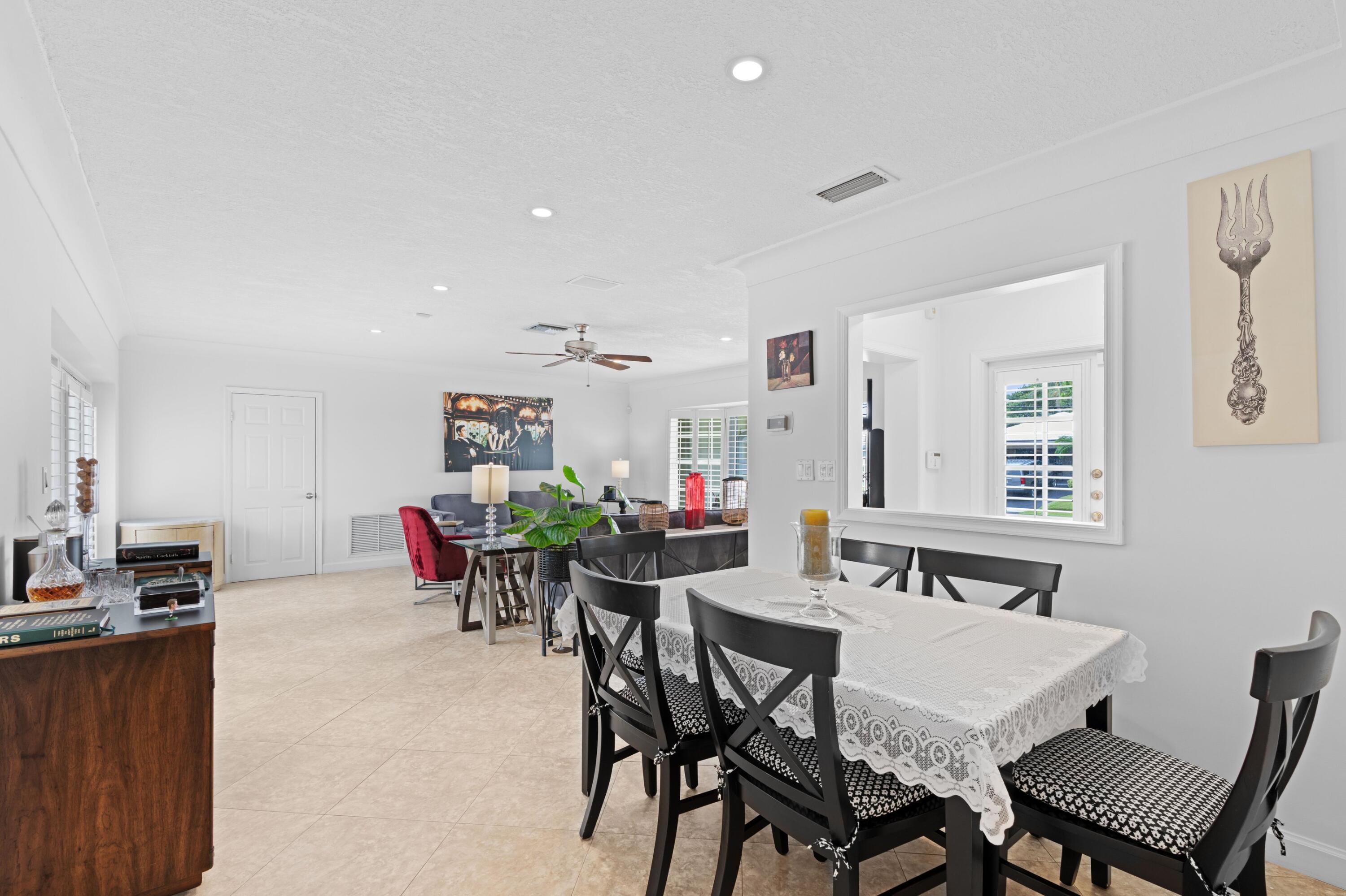 858 Hickory Terrace Boca Raton, FL 33486 - Photo 10 of 43 a view of a dining room with furniture and a livingroom