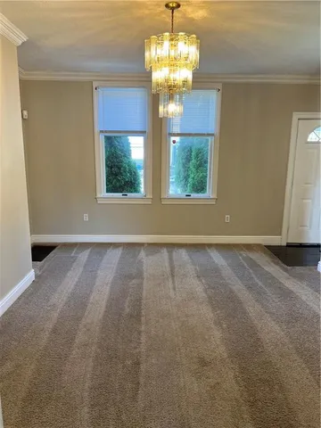 a view of a room with windows and chandelier