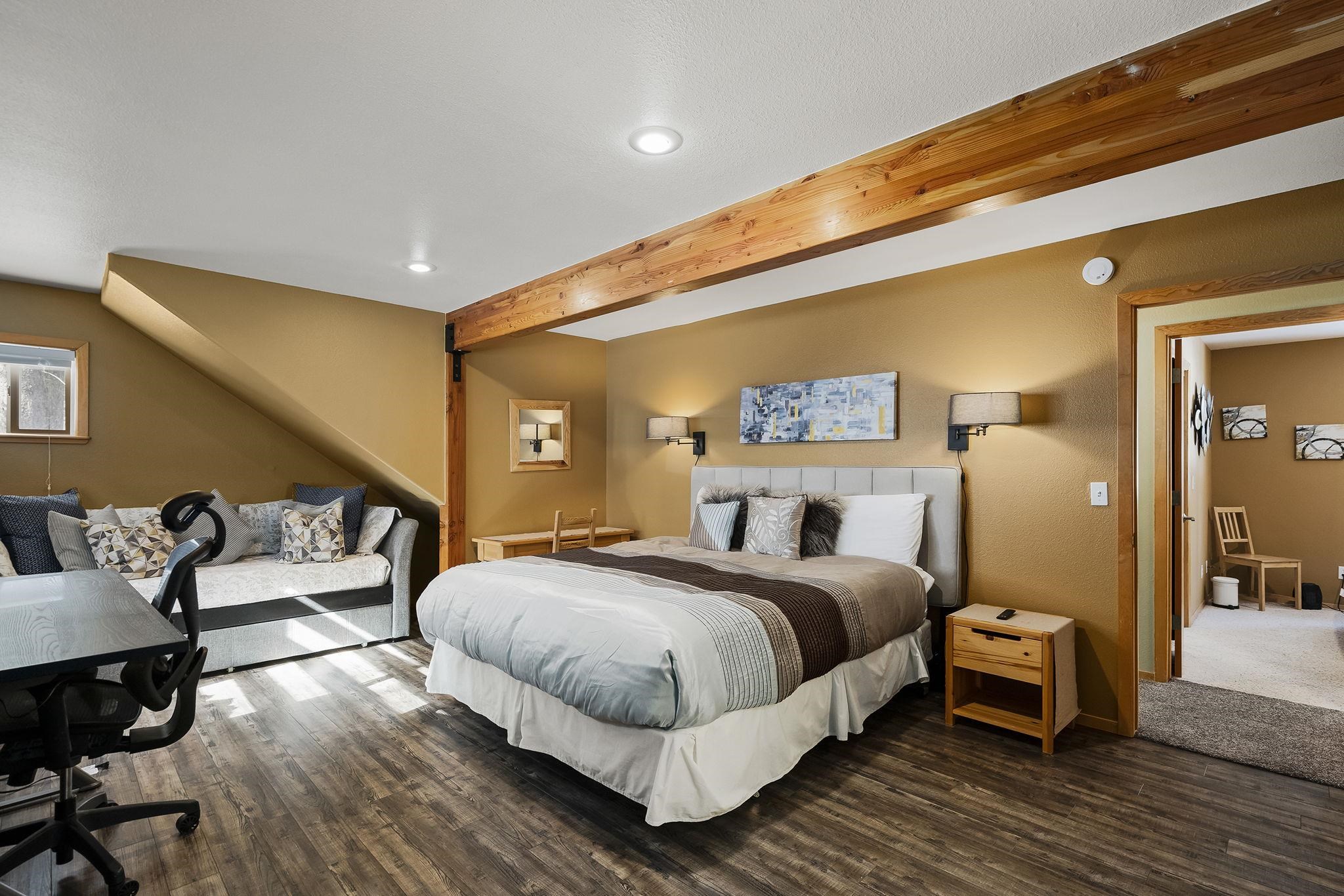 15591 Conifer Drive Truckee, CA 96161 - Photo 19 of 28 a spacious bedroom with a bed and wooden floor