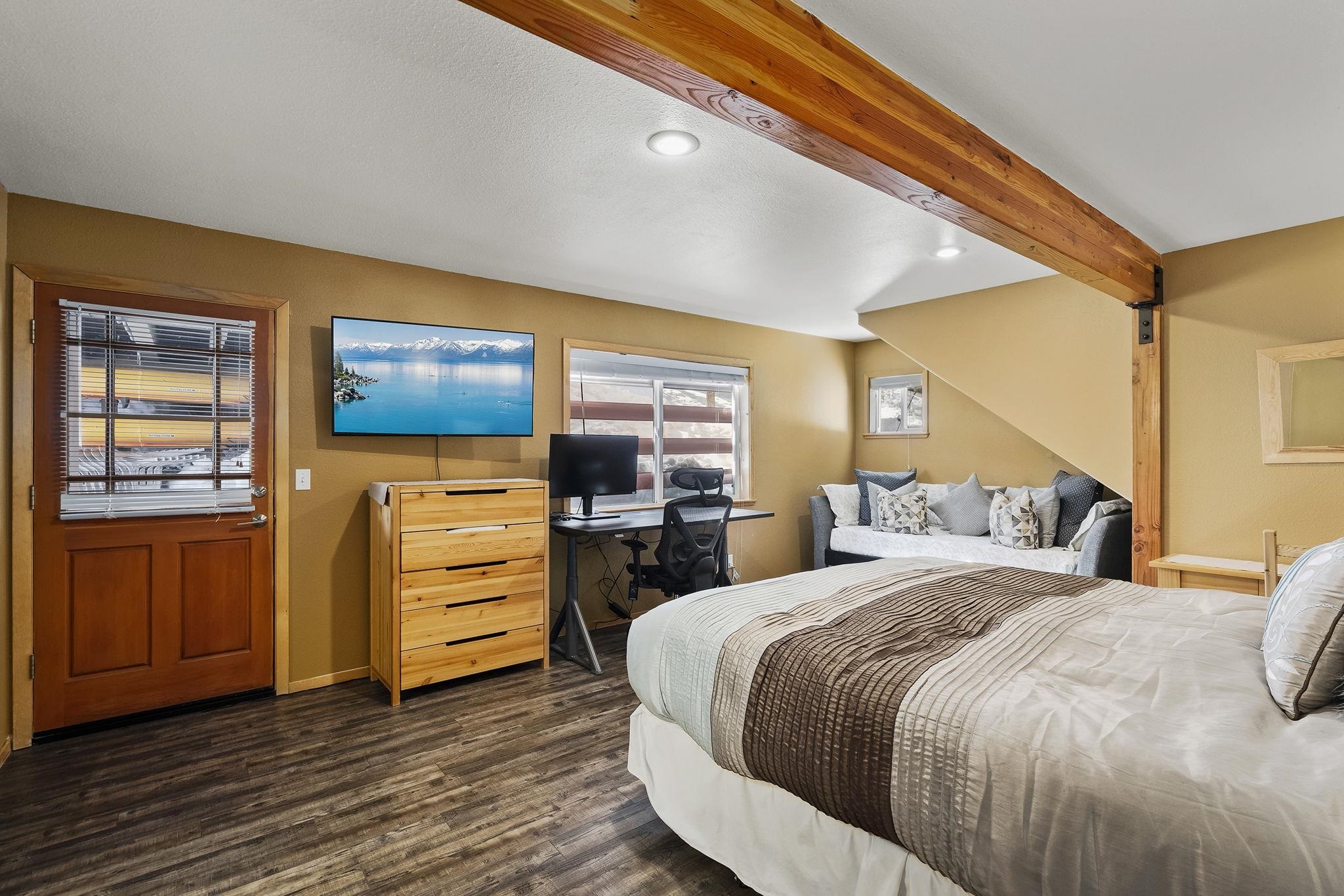 15591 Conifer Drive Truckee, CA 96161 - Photo 20 of 28 a bedroom with a bed and wooden floor