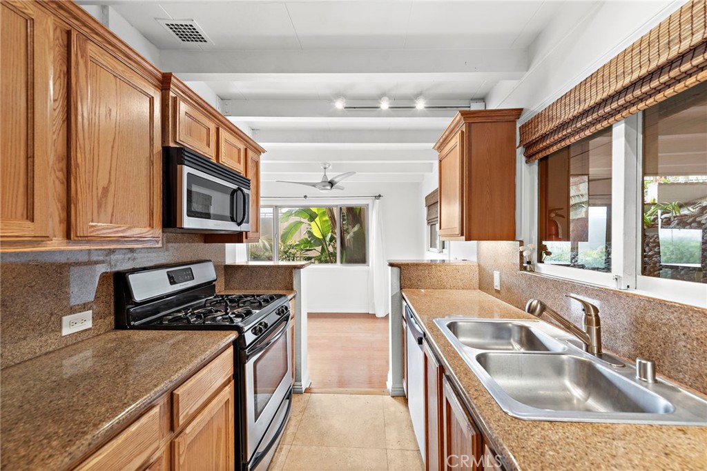 146 Cliff Drive, Unit C Laguna Beach, CA 92651 - Photo 11 of 21 a kitchen that has a sink and a stove