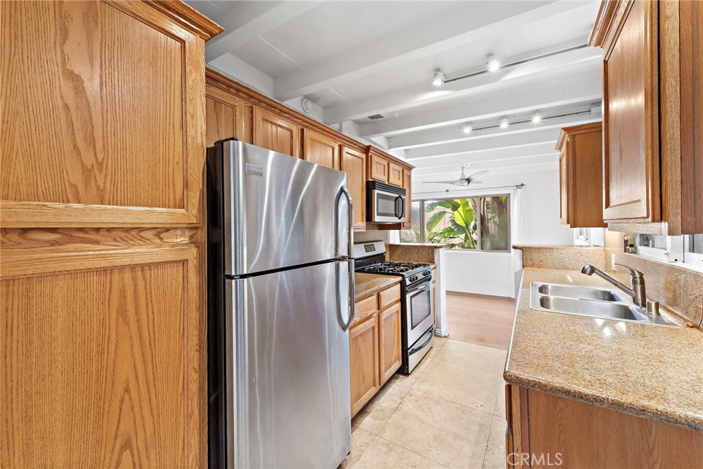 146 Cliff Drive, Unit C Laguna Beach, CA 92651 - Photo 13 of 21 a kitchen with granite countertop a refrigerator and a sink