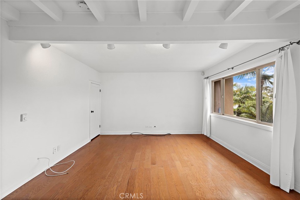 146 Cliff Drive, Unit C Laguna Beach, CA 92651 - Photo 18 of 21 a view of empty room with wooden floor and fan