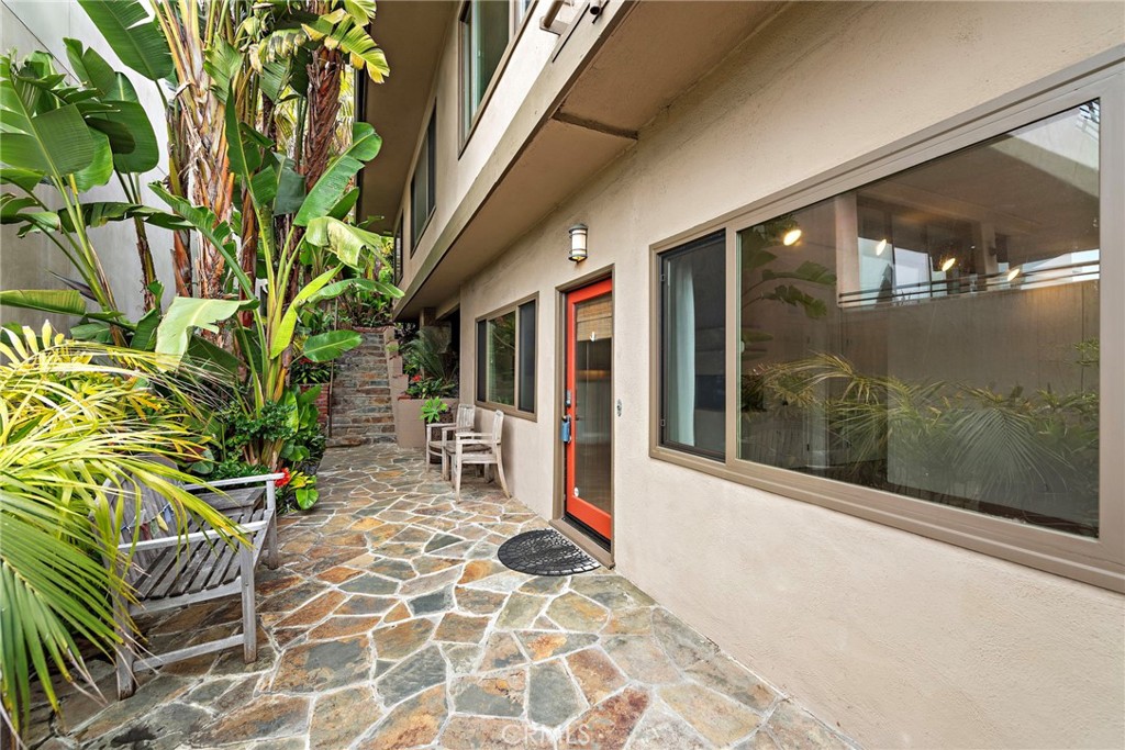 146 Cliff Drive, Unit C Laguna Beach, CA 92651 - Photo 2 of 21 a balcony with table and chairs and potted plants