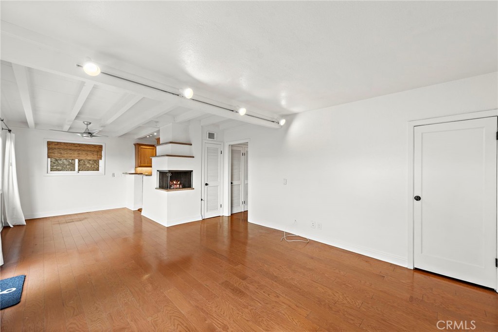 146 Cliff Drive, Unit C Laguna Beach, CA 92651 - Photo 7 of 21 an empty room with wooden floor and windows