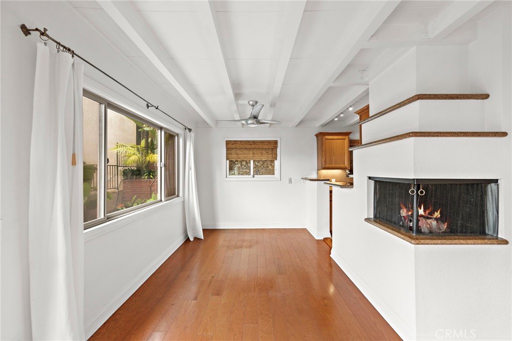 146 Cliff Drive, Unit C Laguna Beach, CA 92651 - Photo 8 of 21 a view of a livingroom with wooden floor and a fireplace