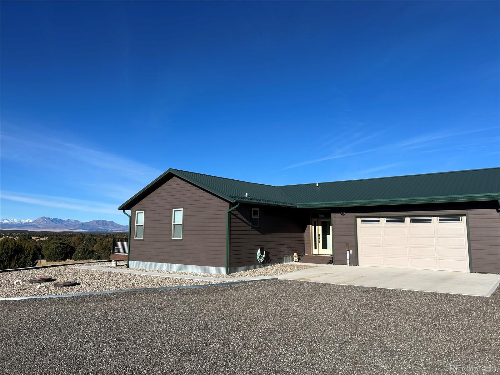 517 Trailsend Road Walsenburg, CO 81089 - Photo 5 of 33 a front view of a house with a yard and garage