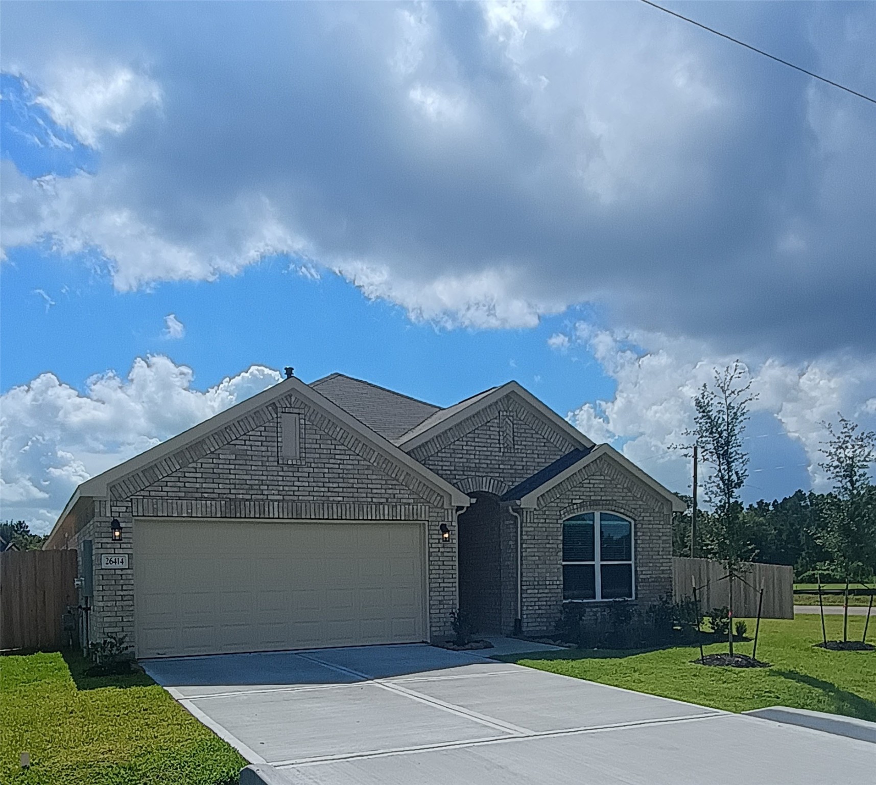a view of a house with a yard and garage