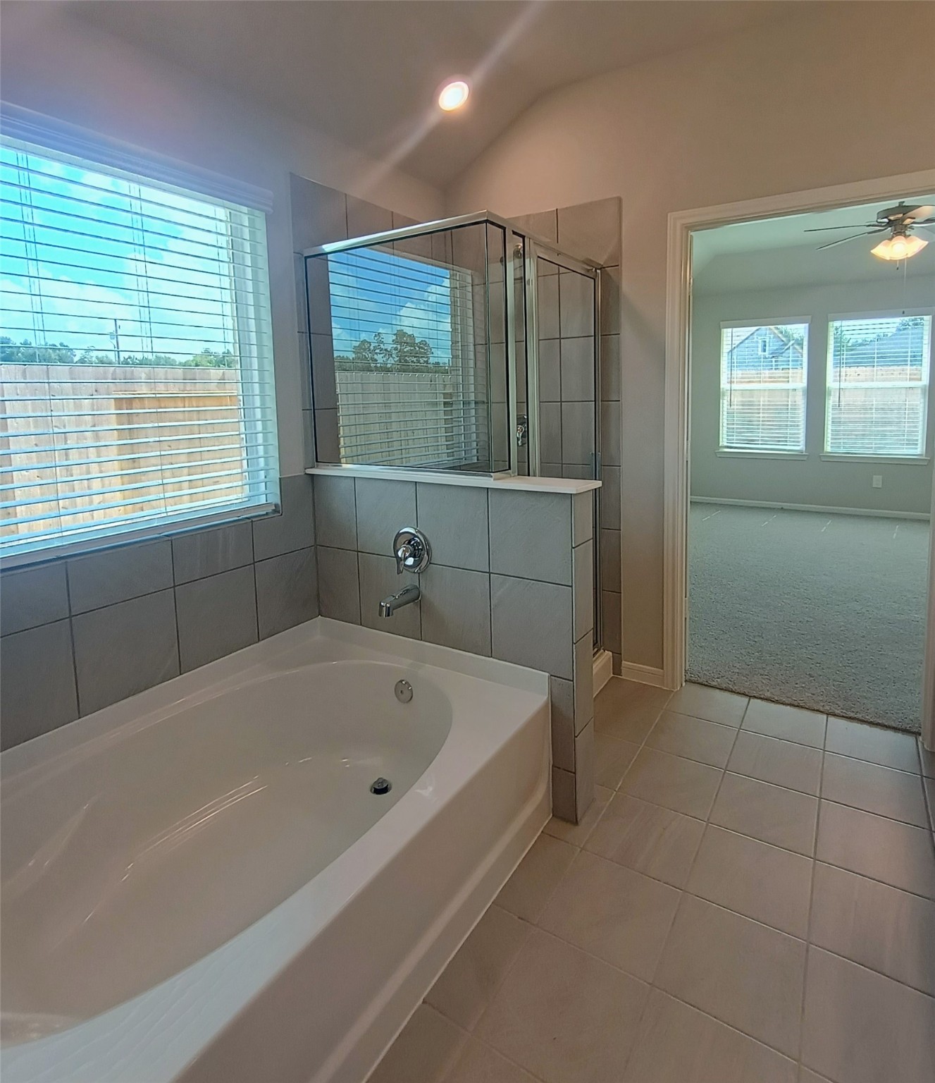 26414 Cooperstown Way Splendora, TX 77372 - Photo 16 of 23 a white bath tub sitting in a bathroom next to a window