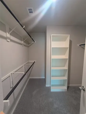 a view of storage and utility room with racks on the wall