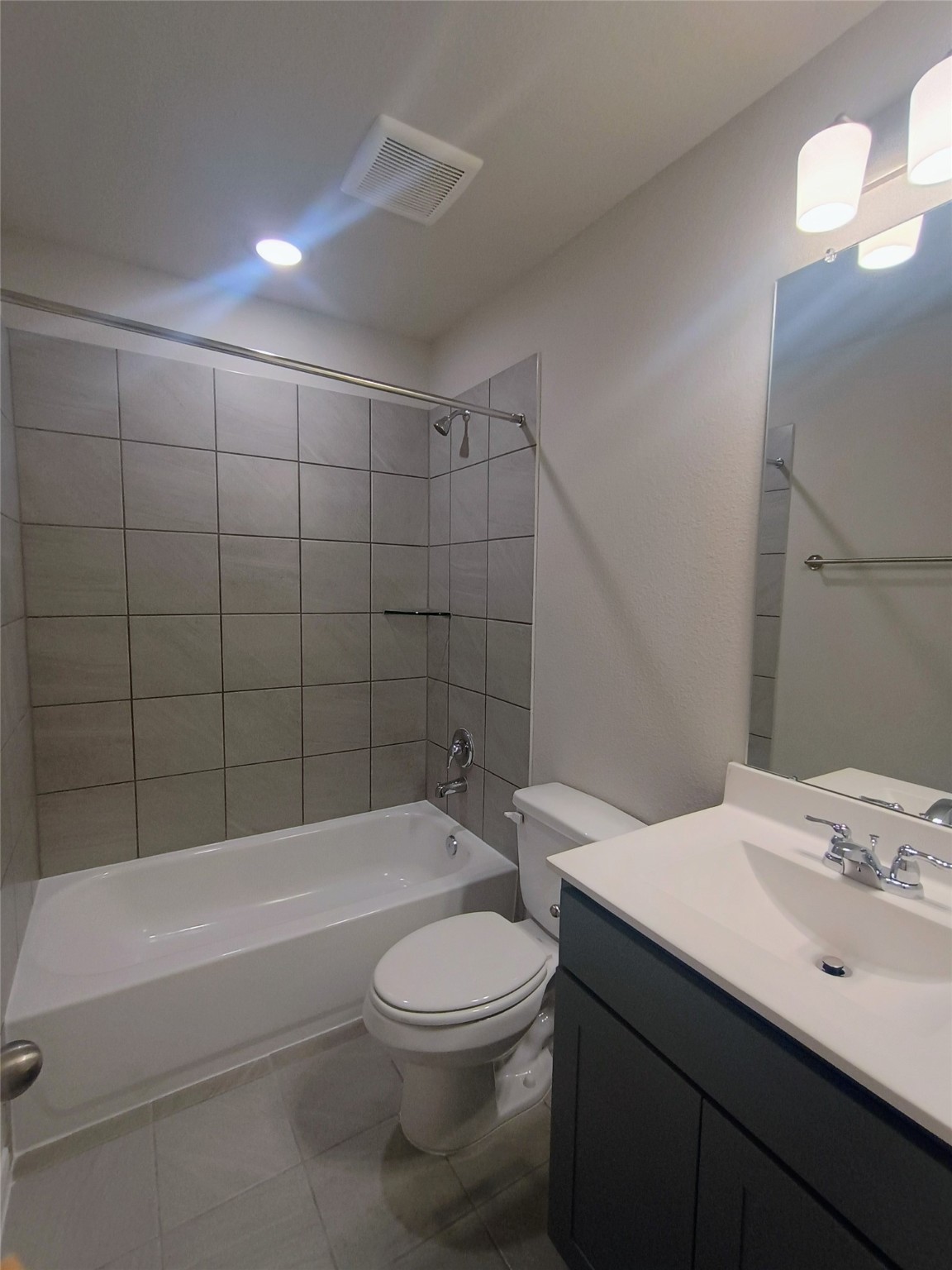 26414 Cooperstown Way Splendora, TX 77372 - Photo 10 of 23 a bathroom with a bathtub a sink a toilet and a mirror