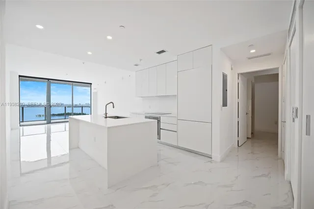 a view of kitchen with center island and stainless steel appliances