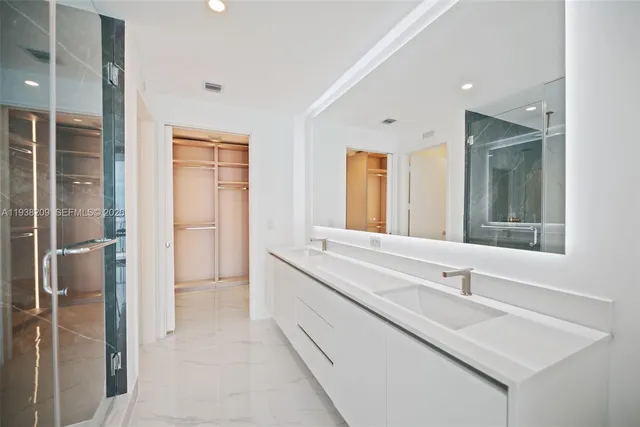a bathroom with a sink double vanity and a mirror