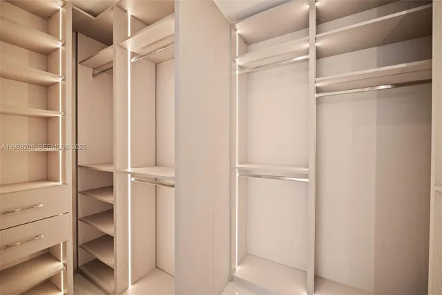 a view of walk in closet with empty racks