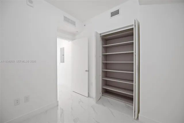 a view of walk in closet with empty racks