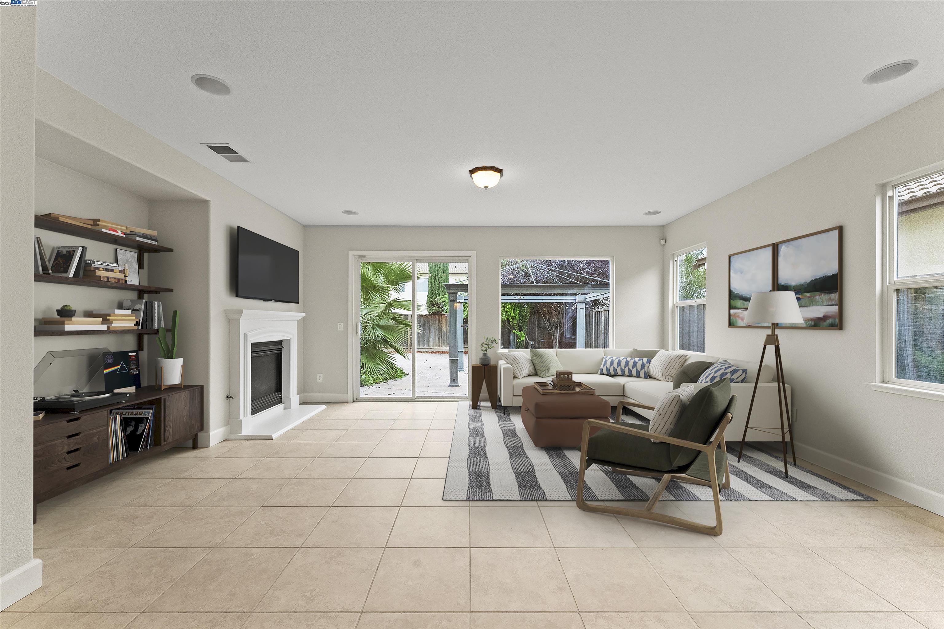 204 Daylilly Lane Patterson, CA 95363 - Photo 13 of 52 a living room with furniture a flat screen tv and a fireplace