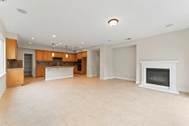 a view of an empty room with a fireplace