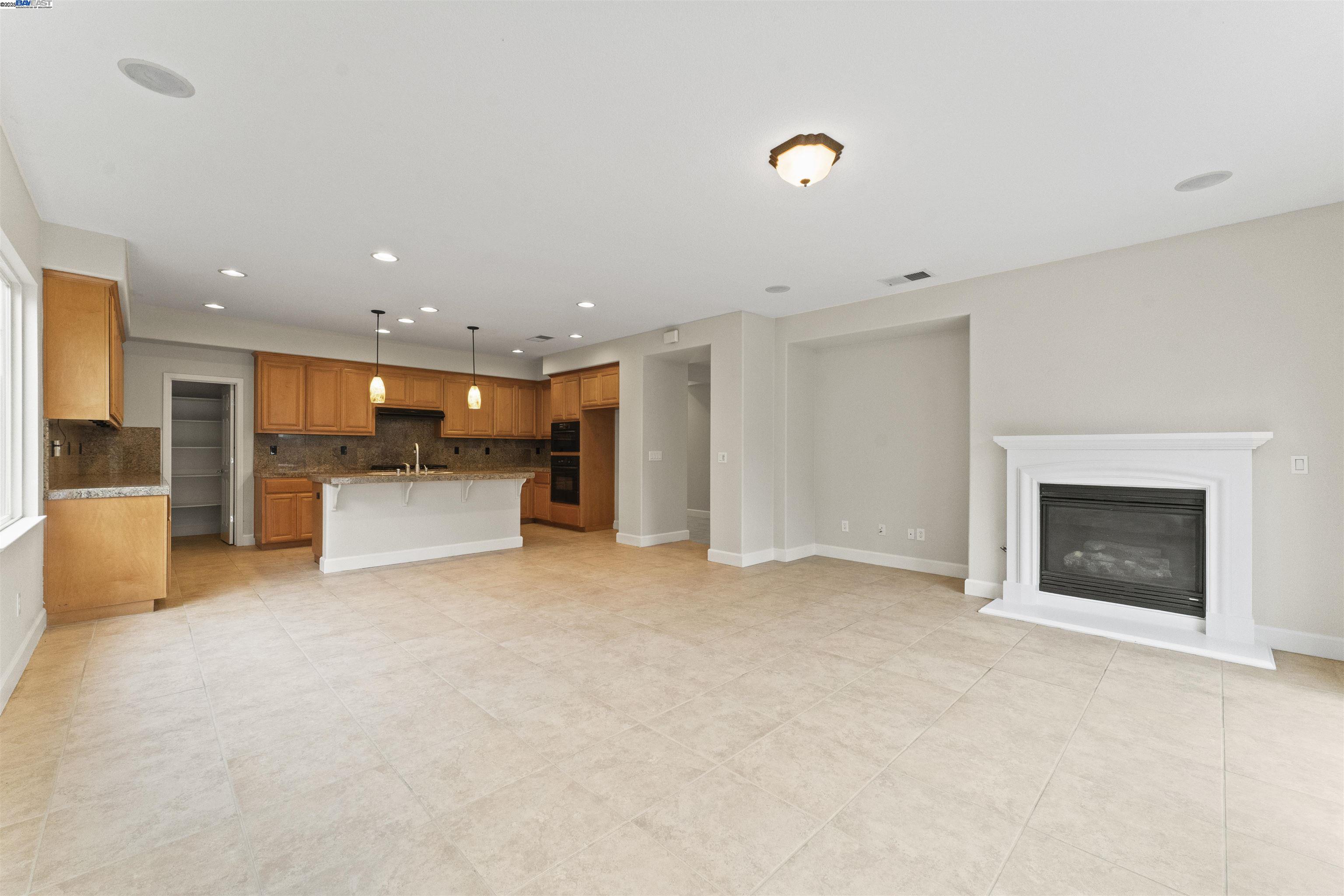 204 Daylilly Lane Patterson, CA 95363 - Photo 14 of 52 a view of an empty room with a fireplace