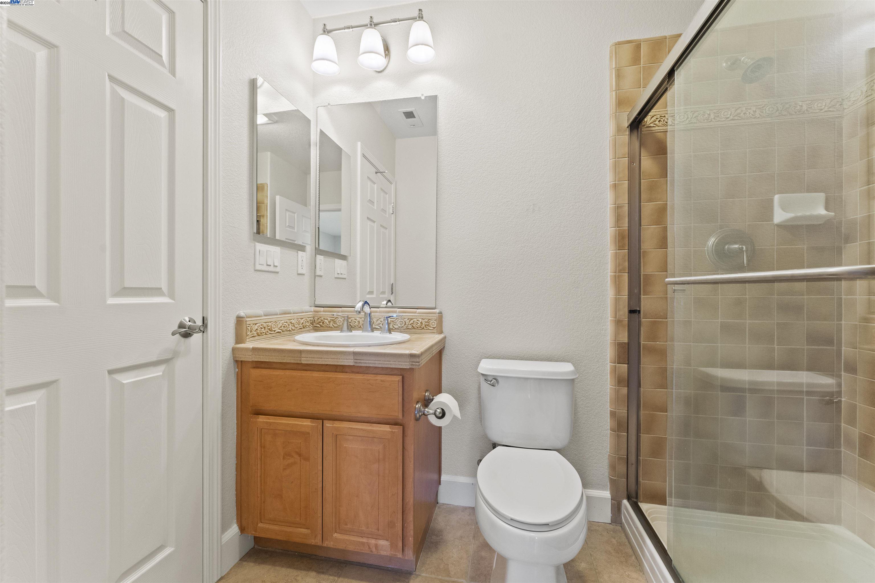 204 Daylilly Lane Patterson, CA 95363 - Photo 21 of 52 a bathroom with a toilet sink and shower
