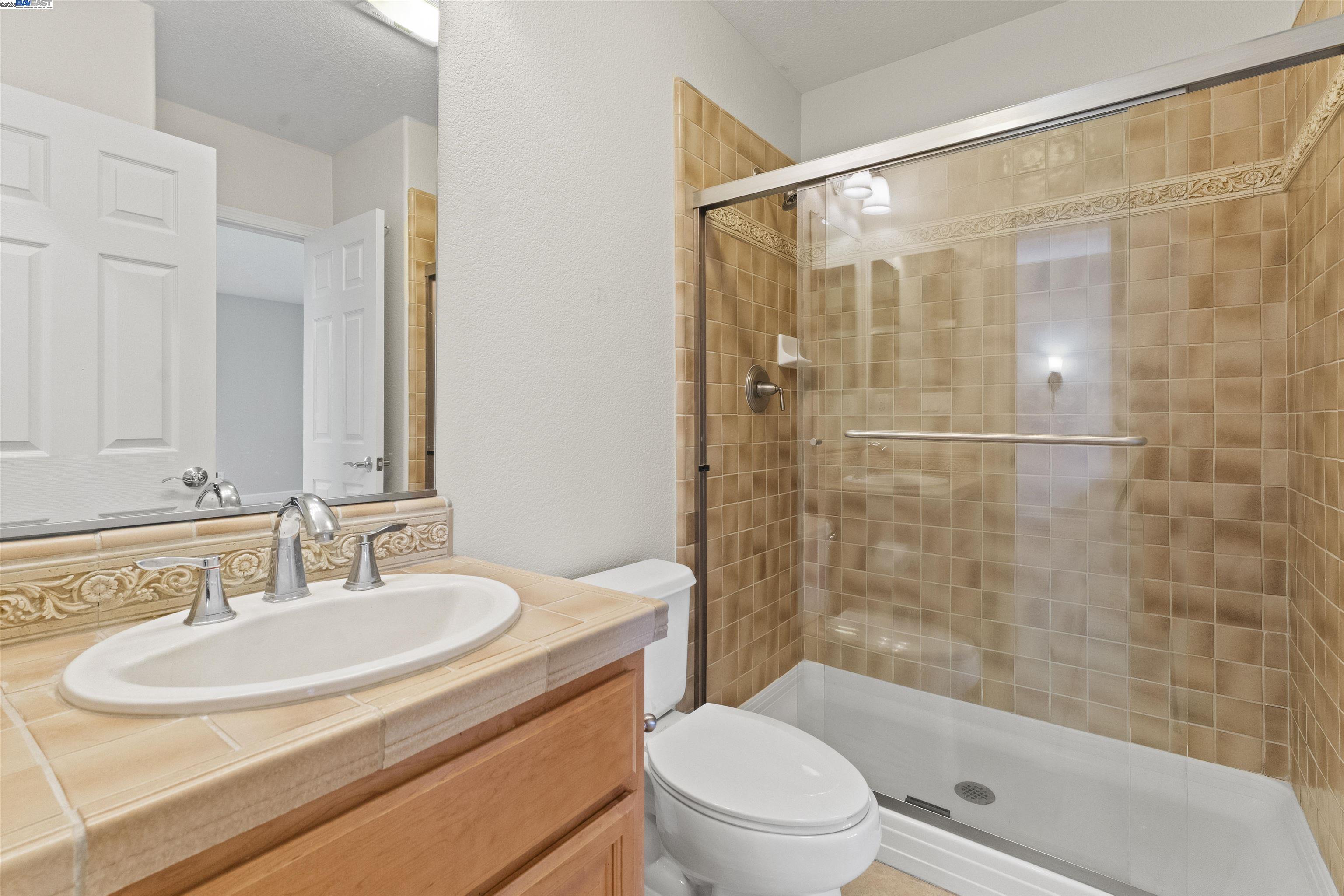 204 Daylilly Lane Patterson, CA 95363 - Photo 22 of 52 a bathroom with a sink toilet and shower