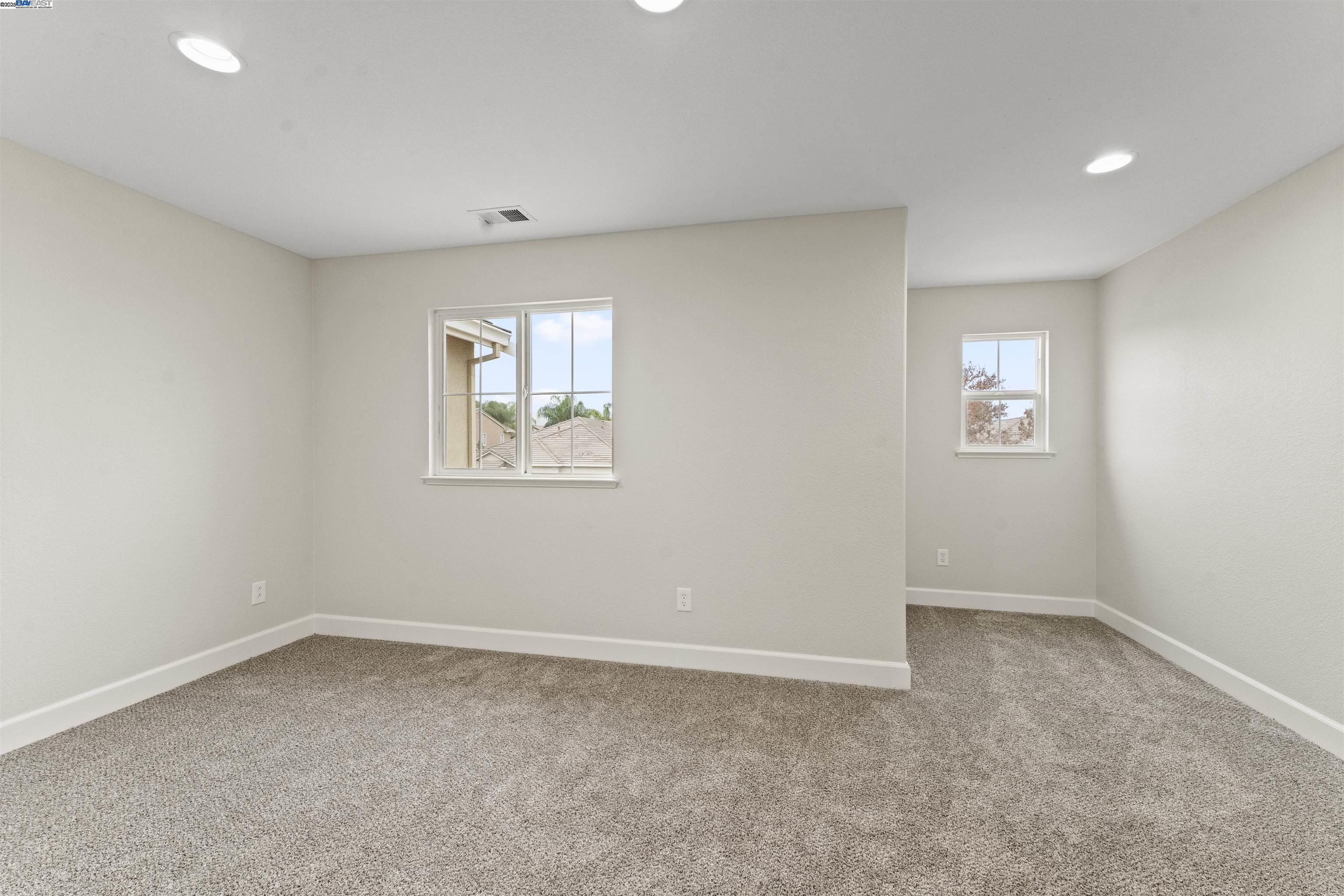 204 Daylilly Lane Patterson, CA 95363 - Photo 29 of 52 an empty room with windows and closet