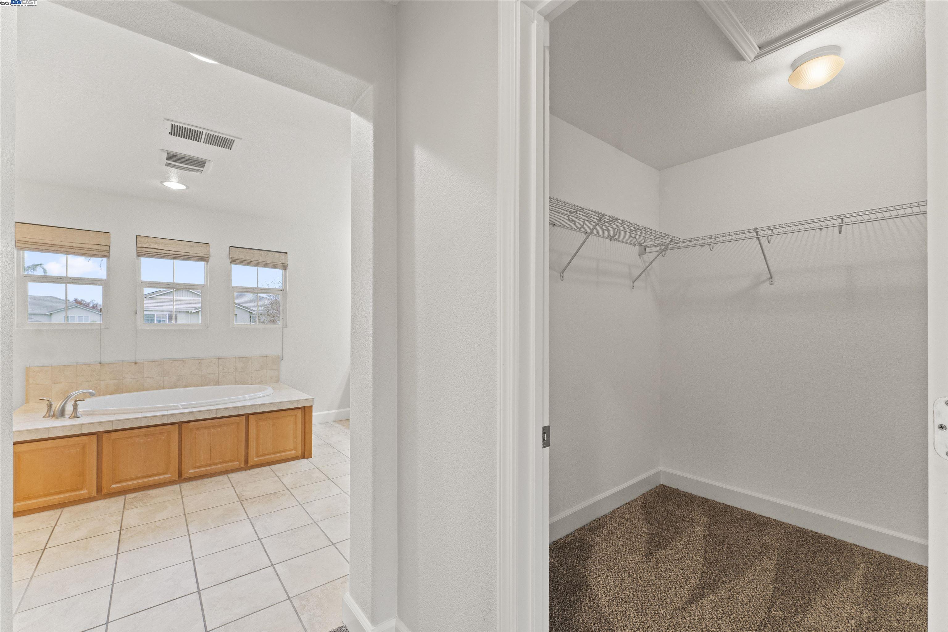 204 Daylilly Lane Patterson, CA 95363 - Photo 43 of 52 a bathroom with a bathtub and a shower
