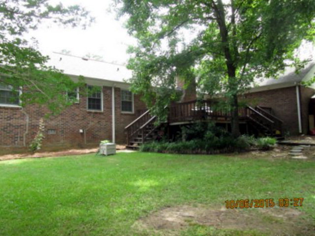 5165 Zebulon Road Macon, GA 31210 - Photo 24 of 28 a backyard of a house with plants and large tree