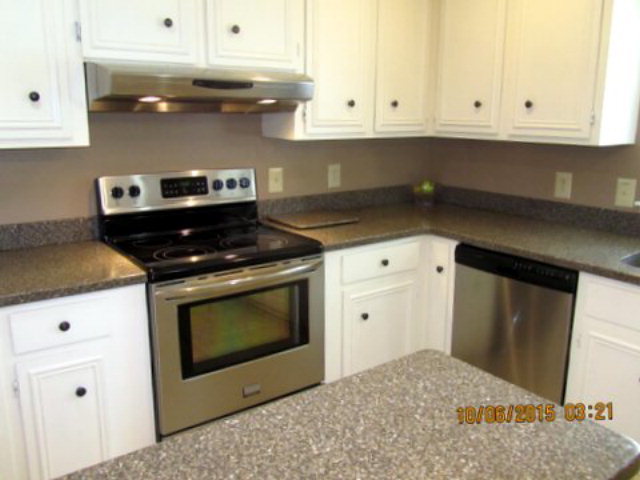 5165 Zebulon Road Macon, GA 31210 - Photo 7 of 28 a kitchen with granite countertop white cabinets and stainless steel appliances