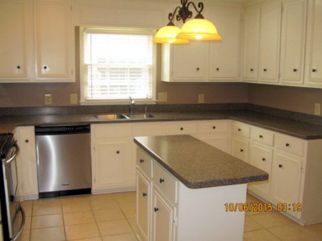 5165 Zebulon Road Macon, GA 31210 - Photo 8 of 28 a kitchen with granite countertop white cabinets and a sink