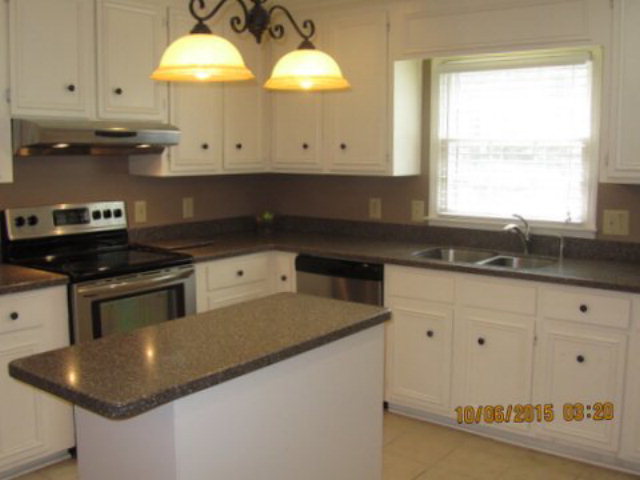 5165 Zebulon Road Macon, GA 31210 - Photo 9 of 28 a kitchen with stainless steel appliances granite countertop a sink a stove and a granite counter tops