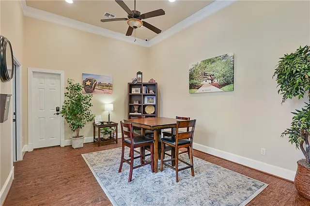 a view of a hallway view with wooden floor and a livingroom