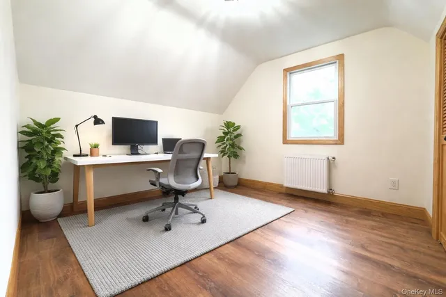 a workspace with furniture and a potted plant
