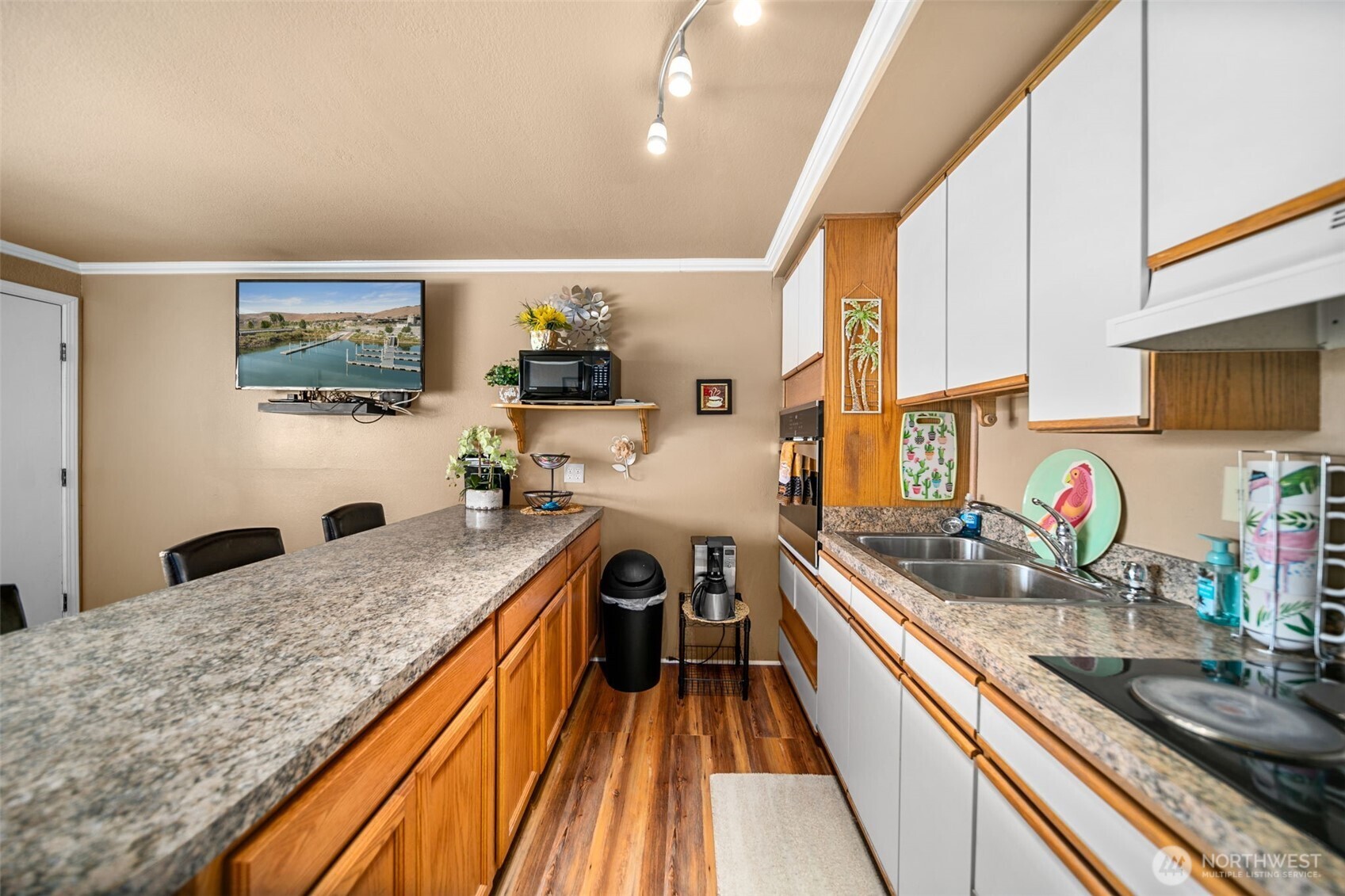 8903 Crescent Bar Road Northwest, Unit 101 Quincy, WA 98848 - Photo 13 of 40 a kitchen with granite countertop lots of counter top space and stainless steel appliances