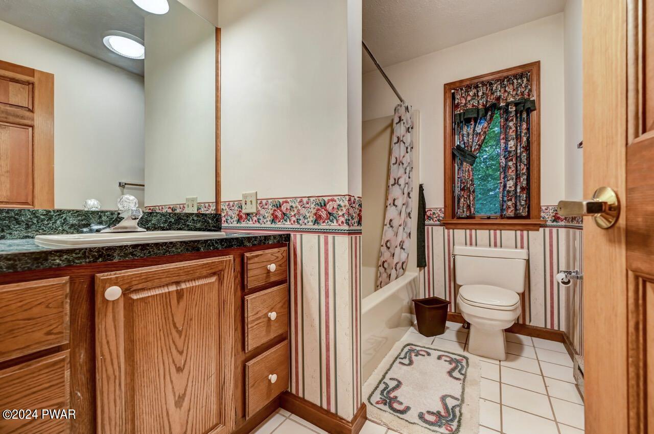 110 Valley Run Road Greentown, PA 18426 - Photo 34 of 67 a bathroom with a granite countertop toilet sink and mirror