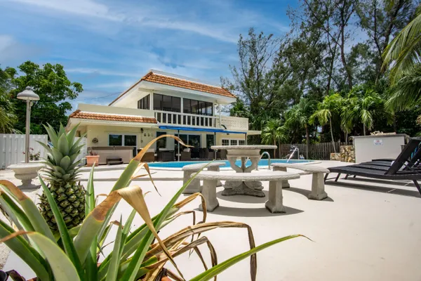 a view of swimming pool with outdoor seating and lake view