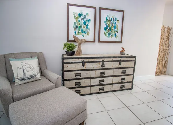 a living room with furniture and a baby crib