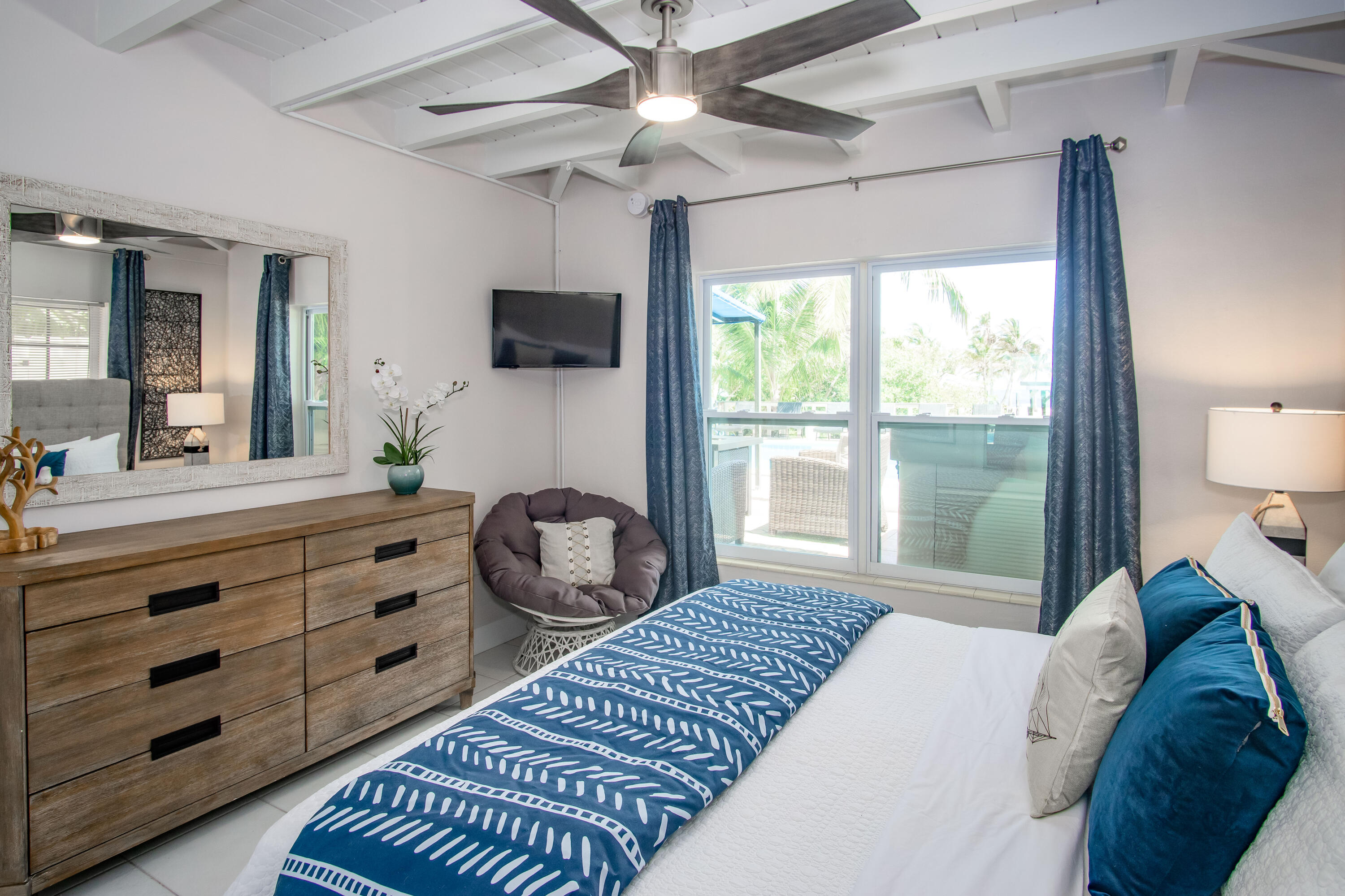 901 46th Street Marathon, FL 33050 - Photo 34 of 79 a bedroom with a large bed and a flat tv screen on dresser