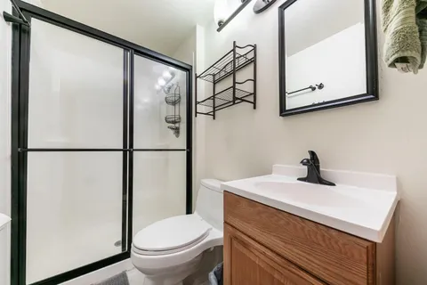 a bathroom with a sink a toilet and shower